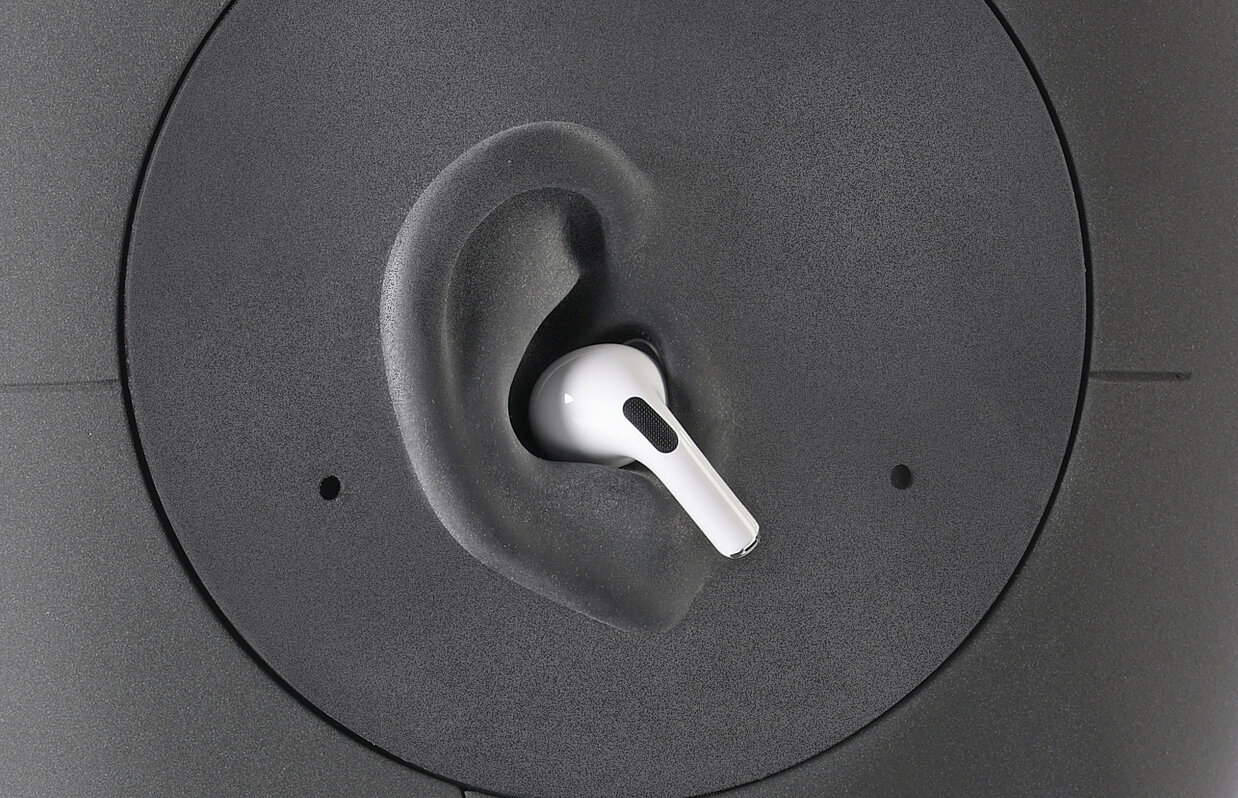 Close-up of an artificial ear with in-ear headset