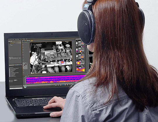 Female person sitting in front of a laptop and working with Visor software
