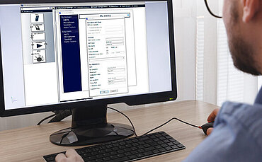 Engineer, Constructor, Designer in Glasses Working on a Personal Computer. He is Creating, Designing a New 3D Model of Aircraft, Airplane in CAD Program. Freelance Work