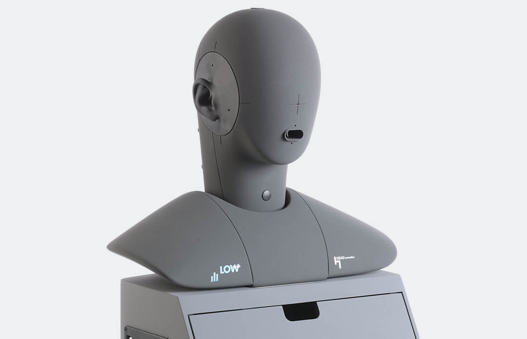 Front view of the artificial head HMS II.3 LN HEC with torso box.